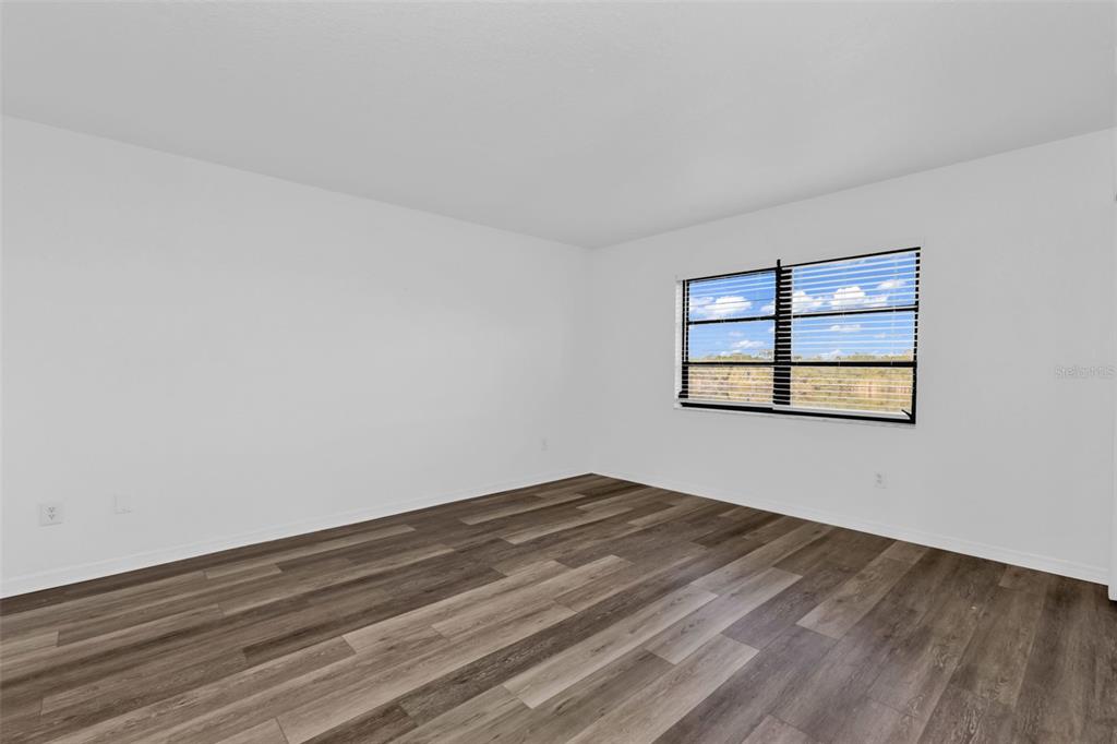 175 Kings Highway, Unit B6526 Punta Gorda, FL 33983 - Photo 17 of 44 a view of an empty room with wooden floor and a window