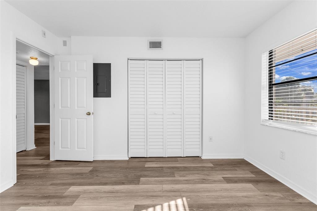 175 Kings Highway, Unit B6526 Punta Gorda, FL 33983 - Photo 19 of 44 a view of an empty room with wooden floor and a window