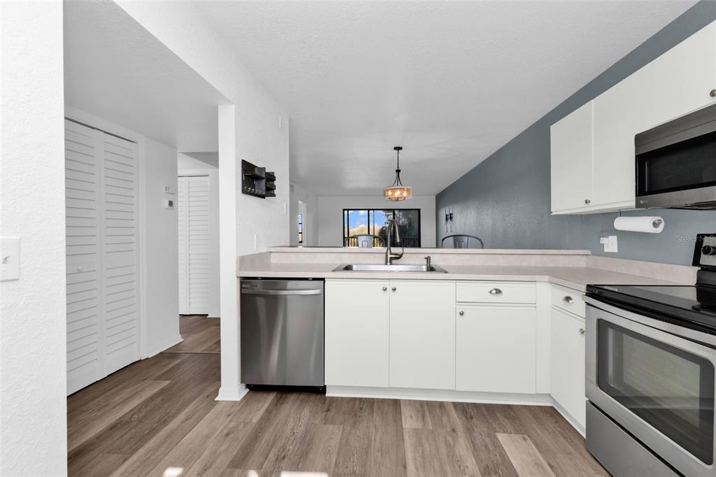 175 Kings Highway, Unit B6526 Punta Gorda, FL 33983 - Photo 7 of 44 a kitchen with a sink stove and microwave