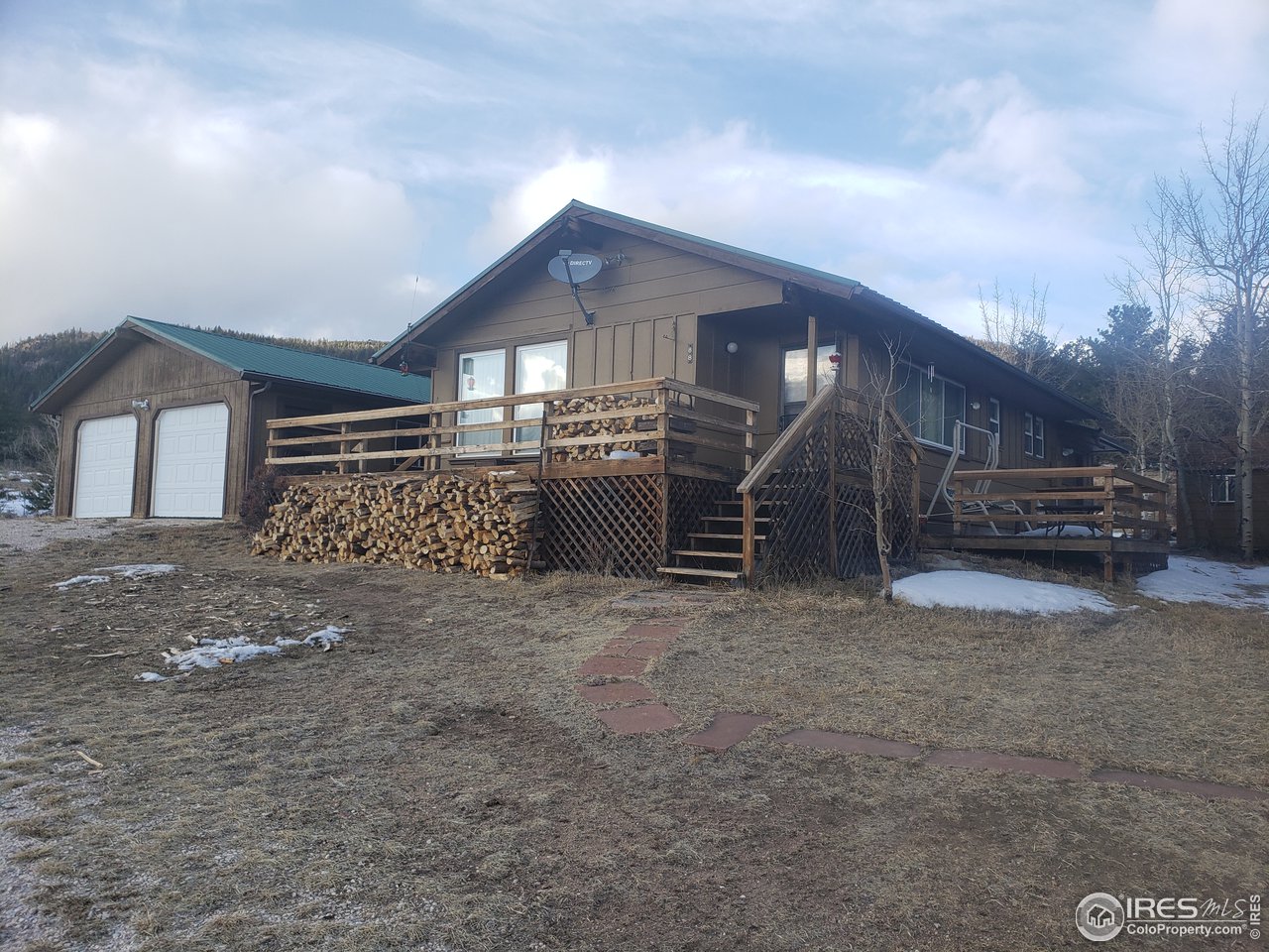 88 Cimarron Road Red Feather Lakes, CO 80545 - Photo 1 of 26 front of cabin with all that firewood split for you!