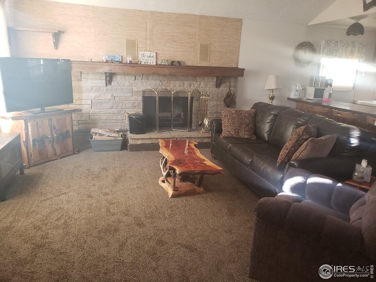 88 Cimarron Road Red Feather Lakes, CO 80545 - Photo 17 of 26 fireplace in the family room