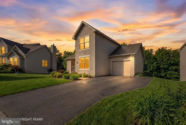 a view of a house with a yard and garage