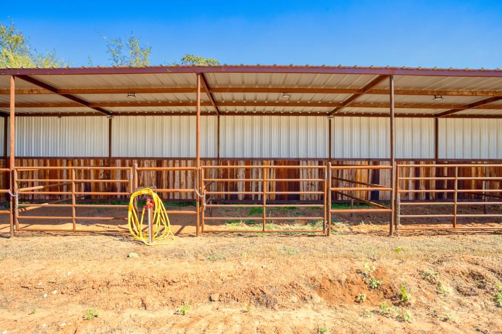 247 South Caddo Street Lipan, TX 76462 - Photo 14 of 29 a view of a backyard with table and chairs