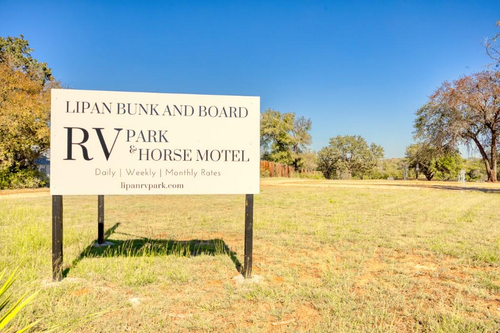 247 South Caddo Street Lipan, TX 76462 - Photo 26 of 29 a sign on the wall next to a road