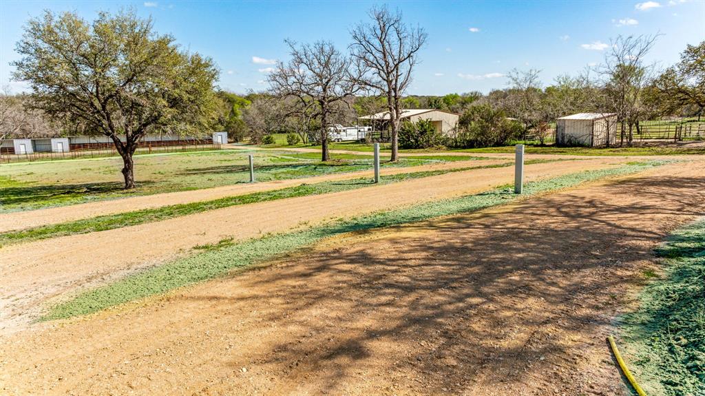 247 South Caddo Street Lipan, TX 76462 - Photo 28 of 29 a view of a yard with a fountain and a large tree