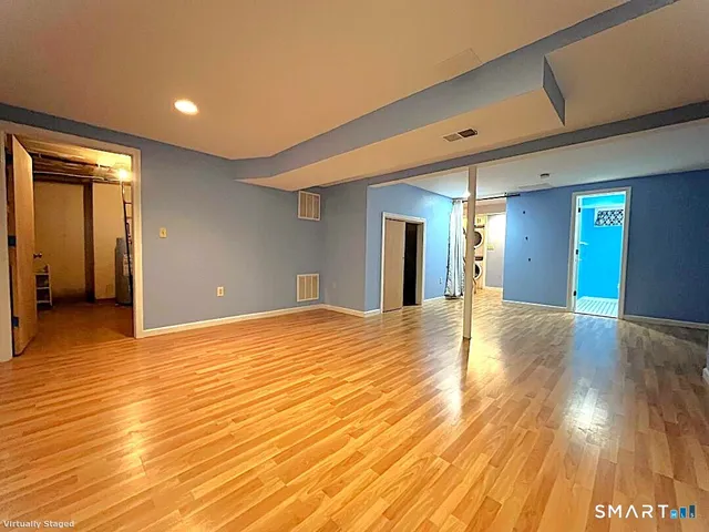 a view of empty room with wooden floor