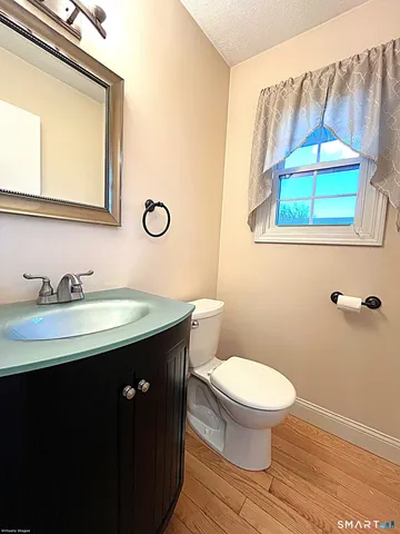 a bathroom with a sink a toilet and a mirror