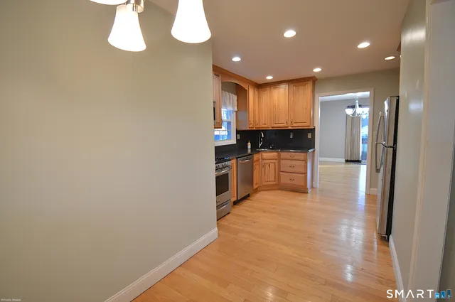 a kitchen with stainless steel appliances a refrigerator and a sink