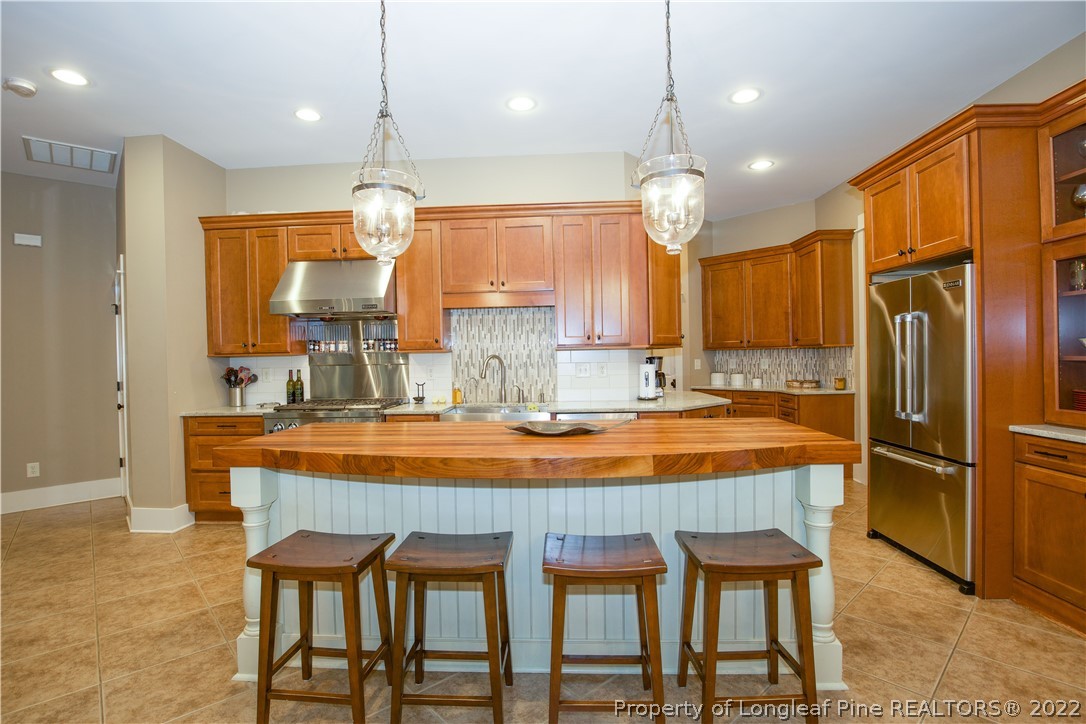 480 Highland Road Southern Pines, NC 28387 - Photo 13 of 50 a dining table chairs refrigerator and microwave
