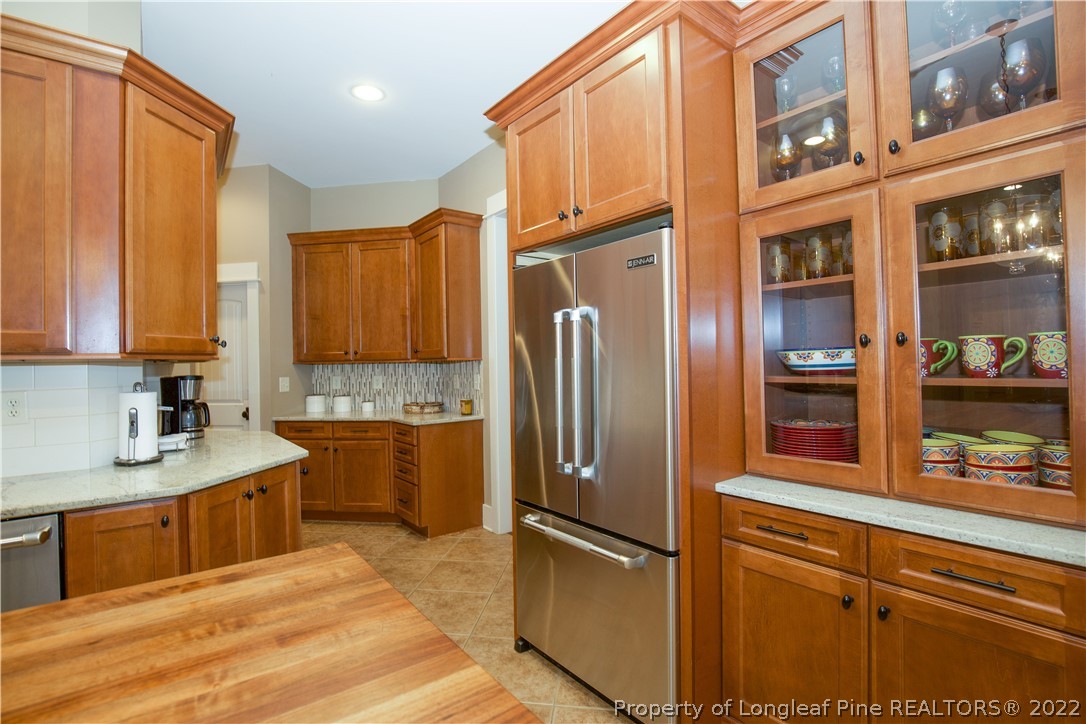 480 Highland Road Southern Pines, NC 28387 - Photo 17 of 50 a kitchen with stainless steel appliances granite countertop a refrigerator and a sink