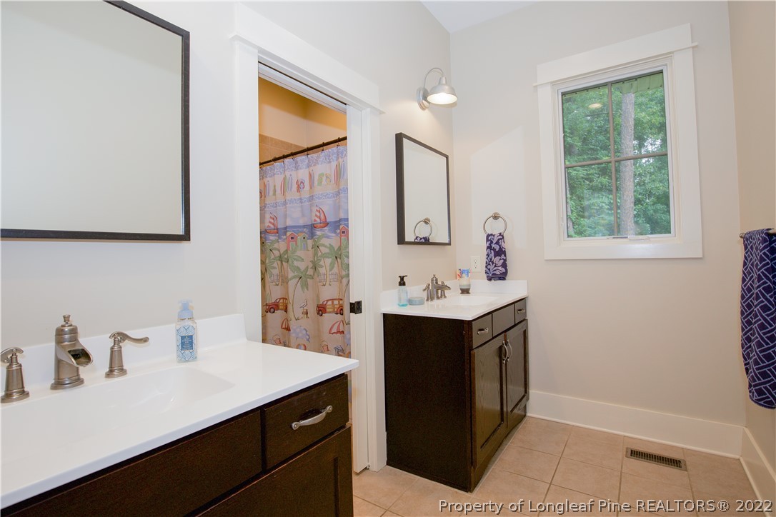 480 Highland Road Southern Pines, NC 28387 - Photo 41 of 50 a bathroom with a sink vanity and a mirror