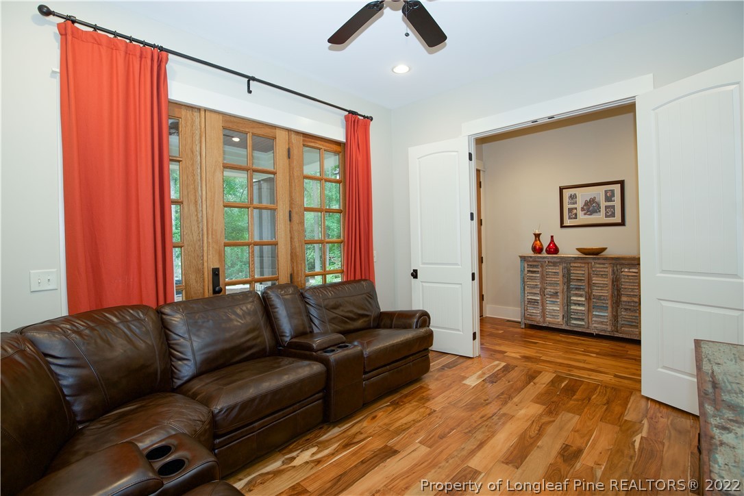 480 Highland Road Southern Pines, NC 28387 - Photo 6 of 50 a living room with furniture a ceiling fan and a rug