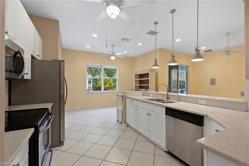 3262 Citron Drive Naples, FL 34120 - Photo 16 of 38 a kitchen with stainless steel appliances granite countertop a refrigerator a sink and a stove
