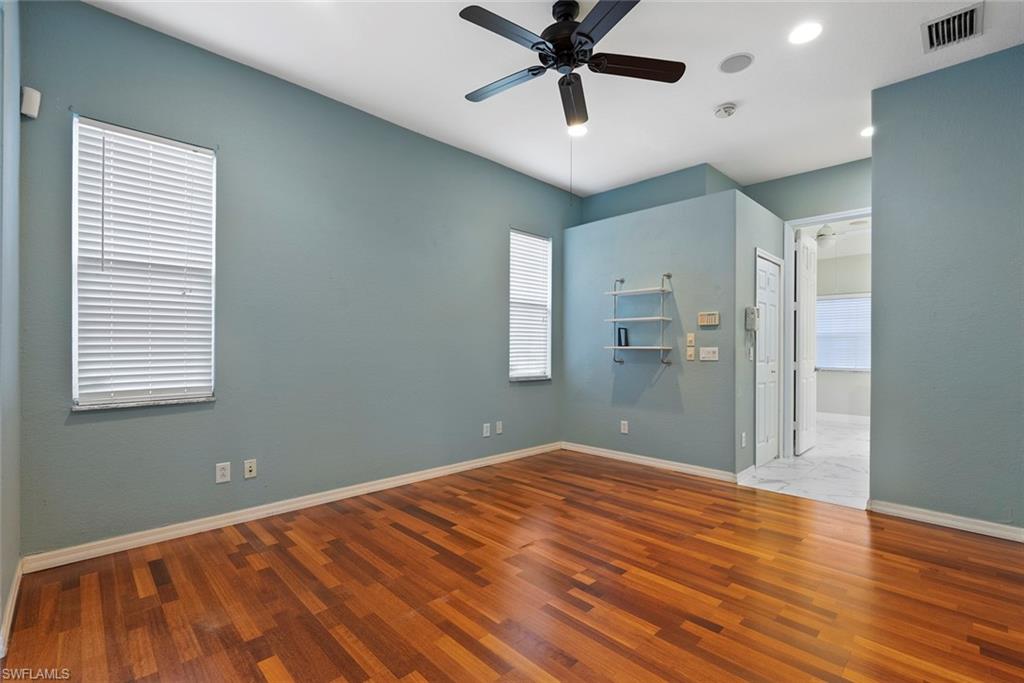 3262 Citron Drive Naples, FL 34120 - Photo 21 of 38 a view of a big room with wooden floor and windows