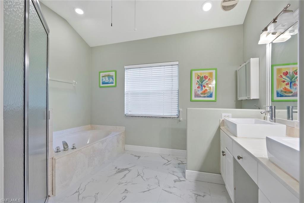 3262 Citron Drive Naples, FL 34120 - Photo 22 of 38 a bathroom with a bathtub sink and mirror