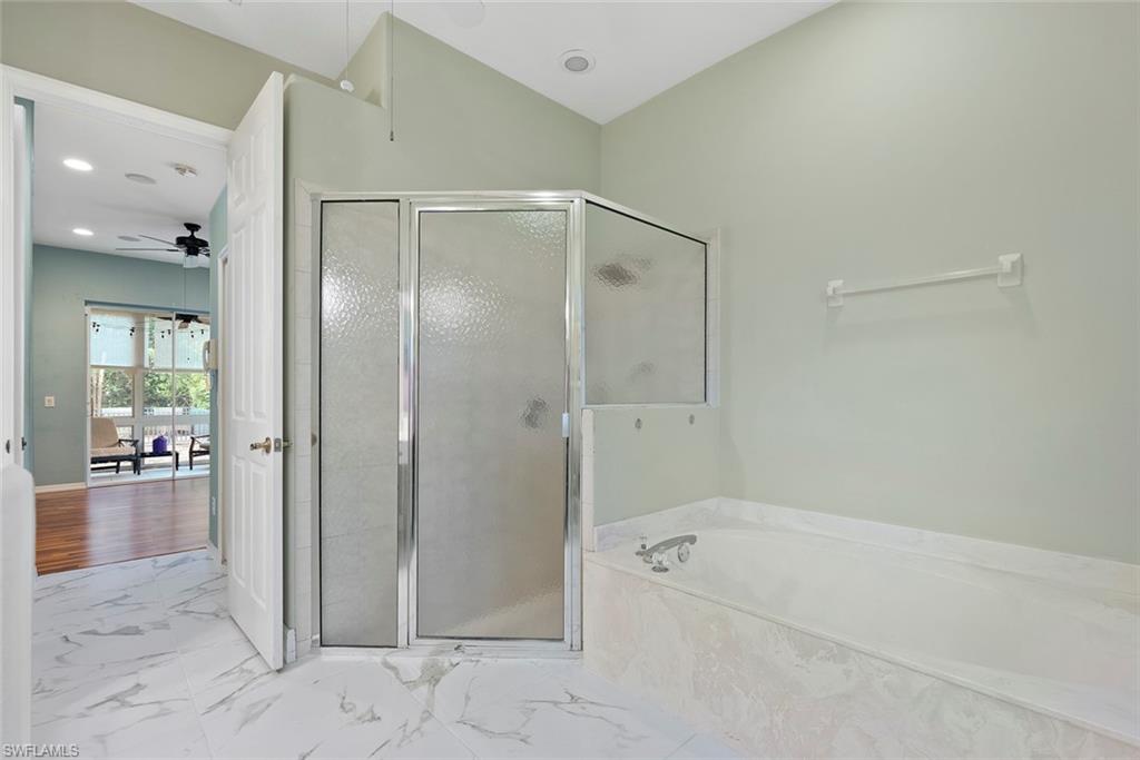 3262 Citron Drive Naples, FL 34120 - Photo 23 of 38 a bathroom with a tub shower and a sink