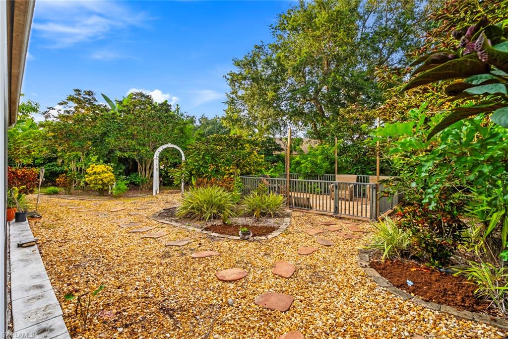 3262 Citron Drive Naples, FL 34120 - Photo 27 of 38 a backyard of a house with table and chairs