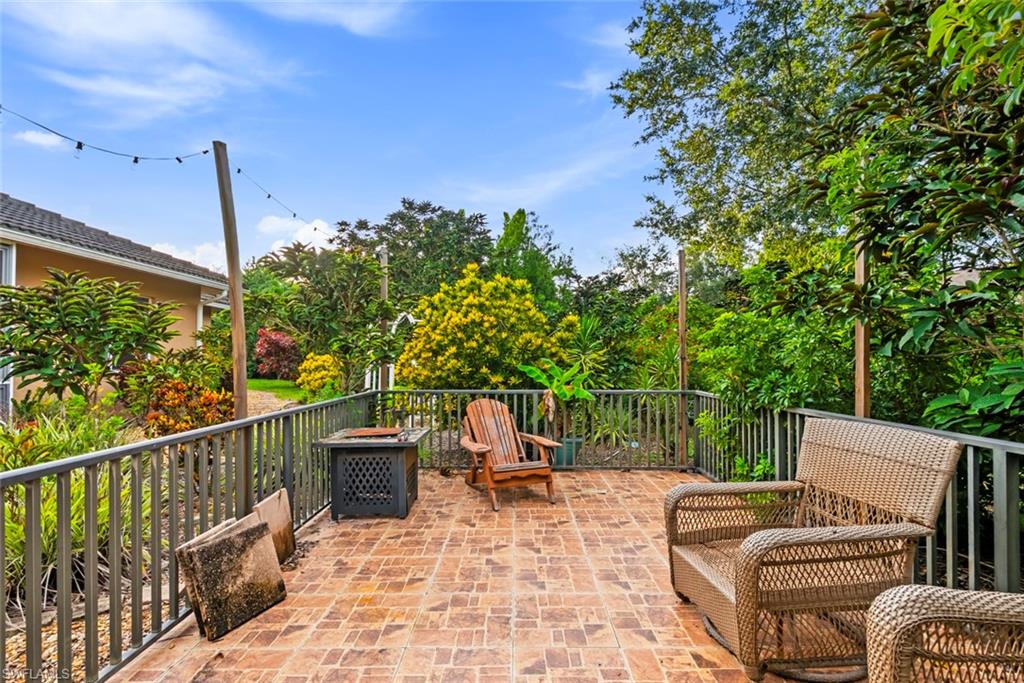3262 Citron Drive Naples, FL 34120 - Photo 29 of 38 a view of a patio with two chairs and a table