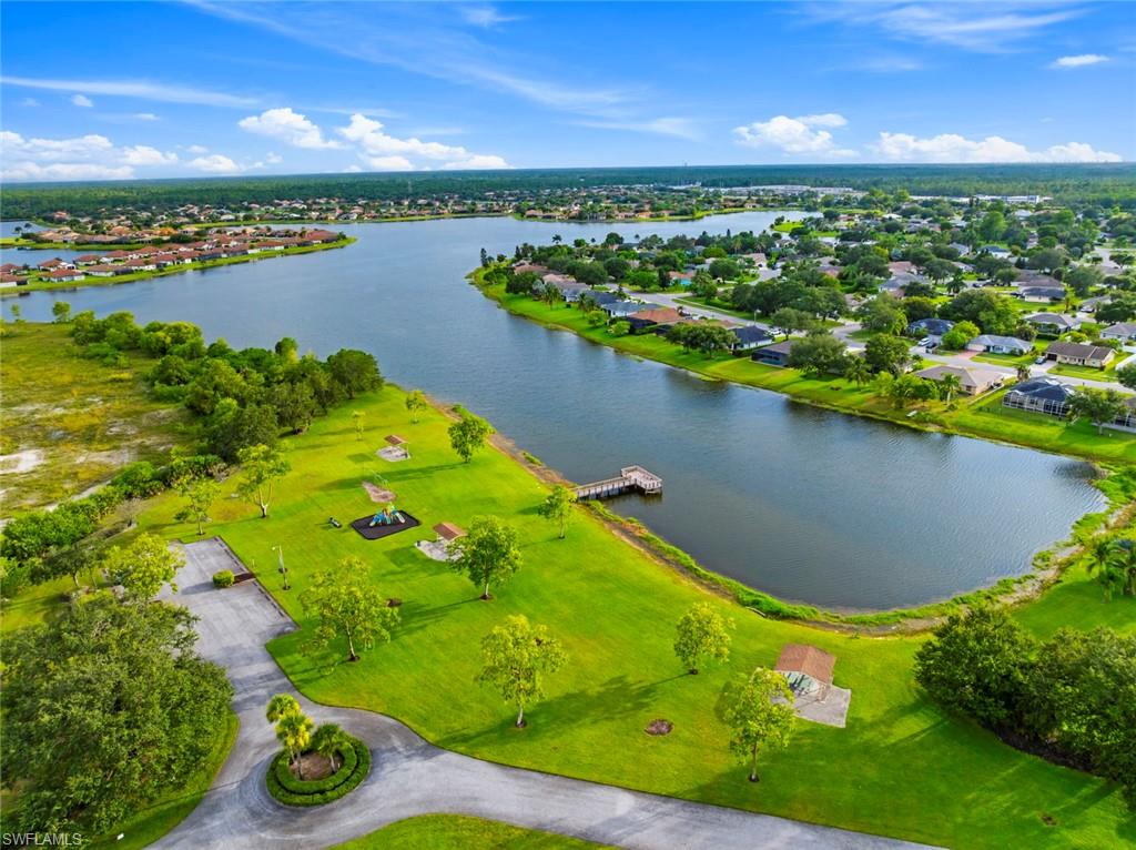 3262 Citron Drive Naples, FL 34120 - Photo 34 of 38 a view of a lake and a yard