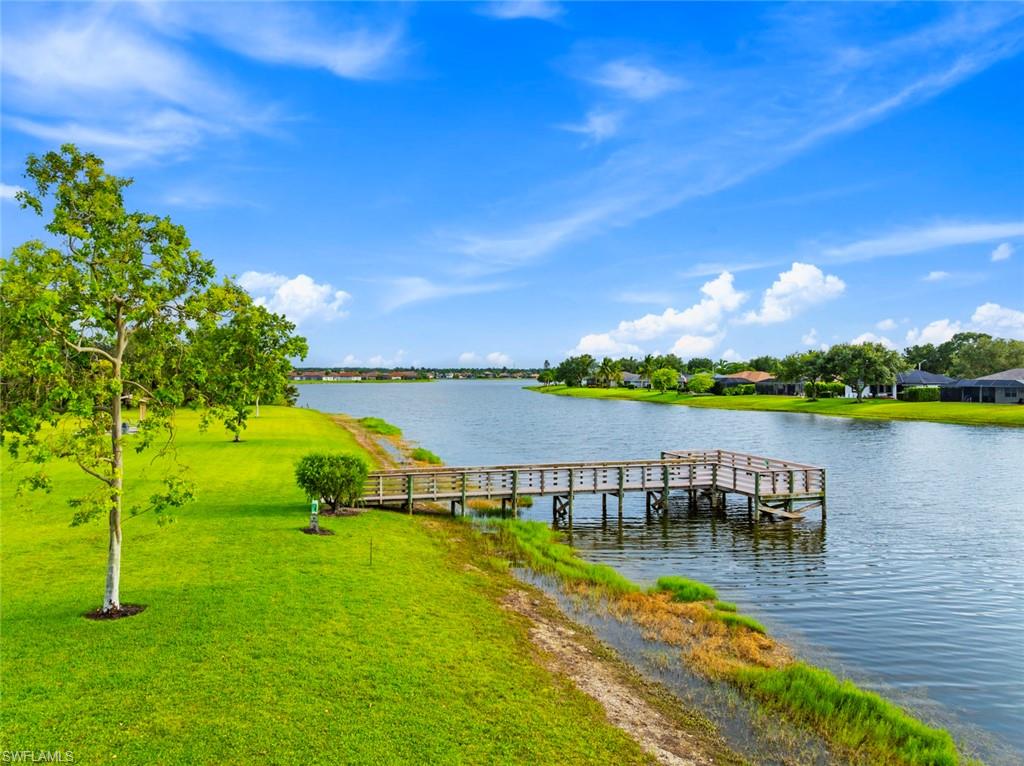 3262 Citron Drive Naples, FL 34120 - Photo 36 of 38 a view of a lake with a house in the background