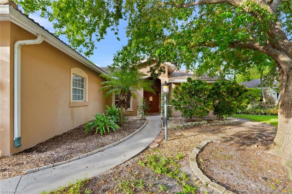 3262 Citron Drive Naples, FL 34120 - Photo 5 of 38 a view of a house with a small yard