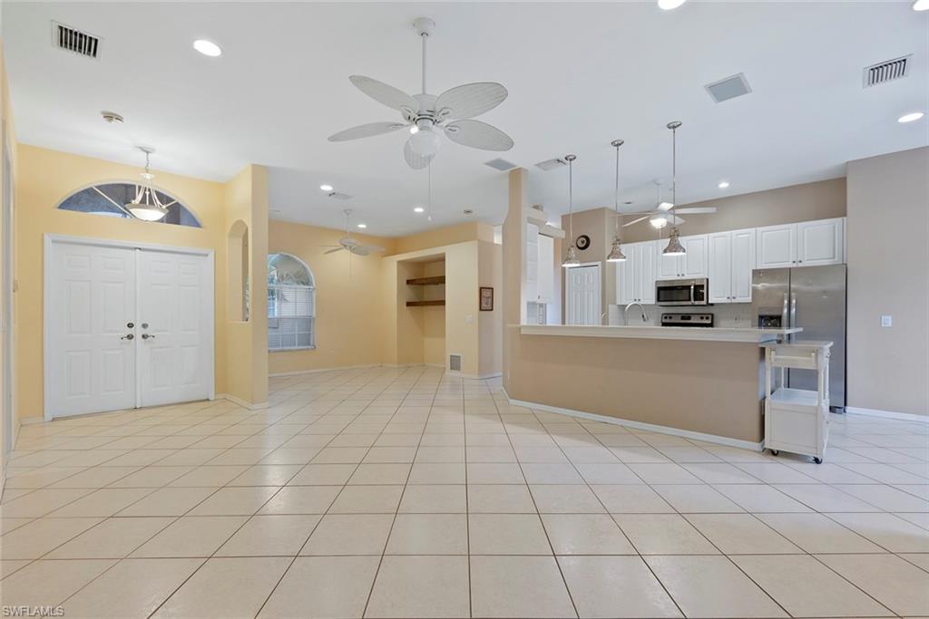 3262 Citron Drive Naples, FL 34120 - Photo 8 of 38 a view of a kitchen with windows and refrigerator