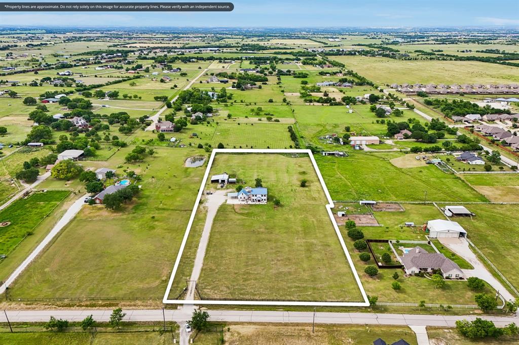 331 Radecke Road Krum, TX 76249 - Photo 2 of 40 Expansive rural property featuring a primary residence with a long driveway, a secondary structure, and substantial acreage