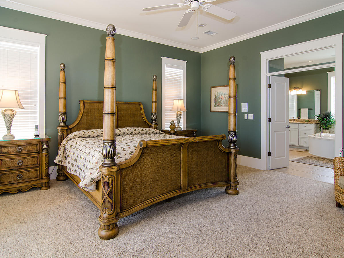 617 Blue Mountain Road Santa Rosa Beach, FL 32459 - Photo 14 of 24 a bedroom with a bed and a chandelier