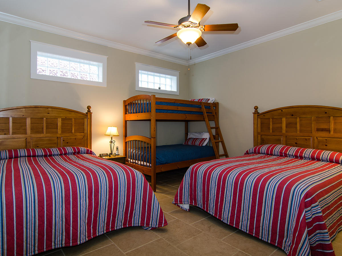 617 Blue Mountain Road Santa Rosa Beach, FL 32459 - Photo 19 of 24 a bedroom with two beds and a window