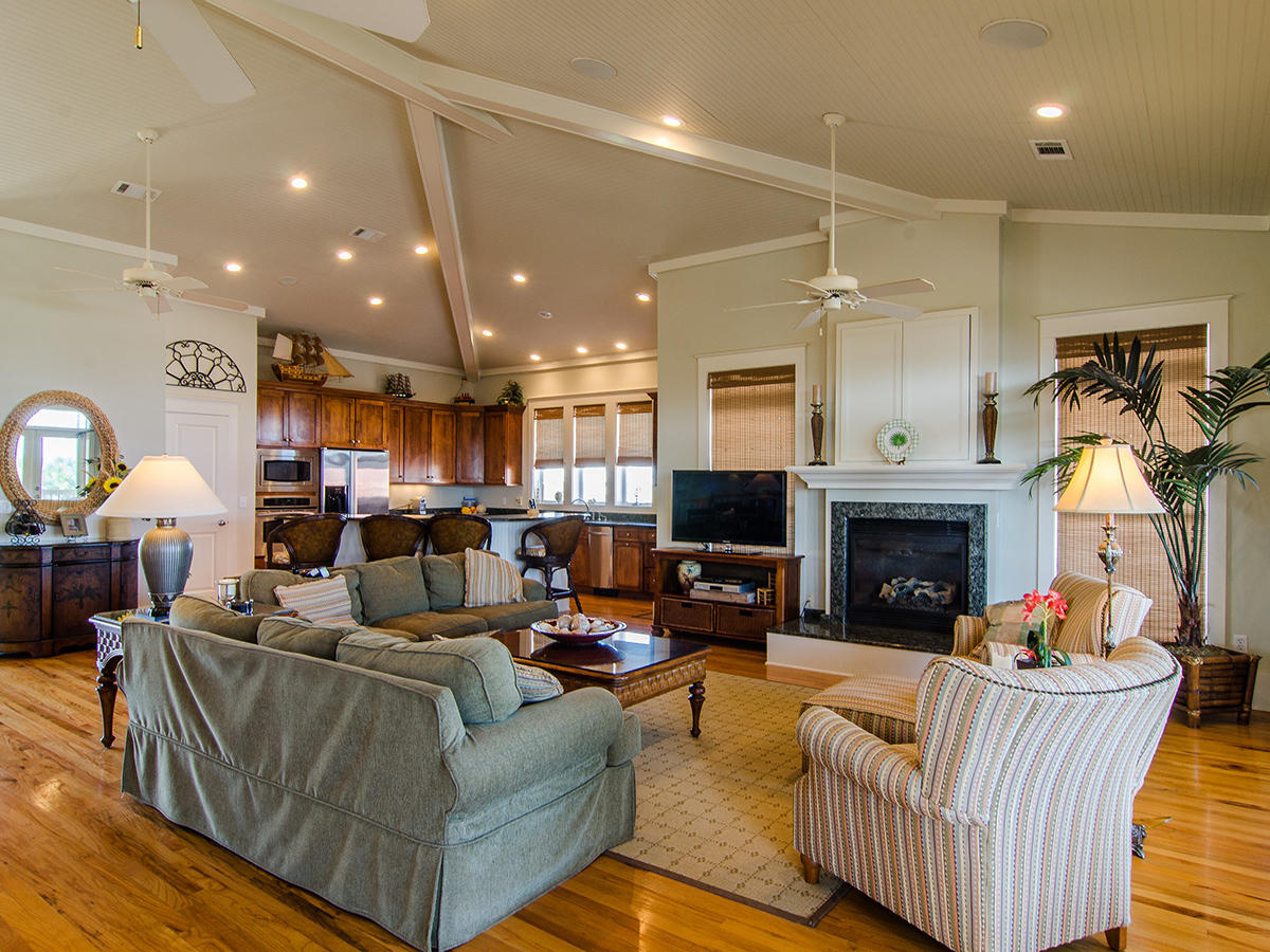 617 Blue Mountain Road Santa Rosa Beach, FL 32459 - Photo 2 of 24 a living room with furniture a fireplace and a chandelier