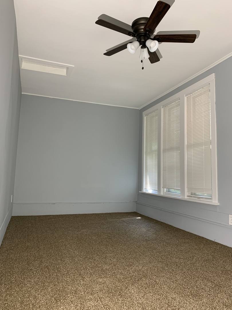 370 Ryerson Avenue Elgin, IL 60123 - Photo 20 of 21 an empty room with a window and a ceiling fan