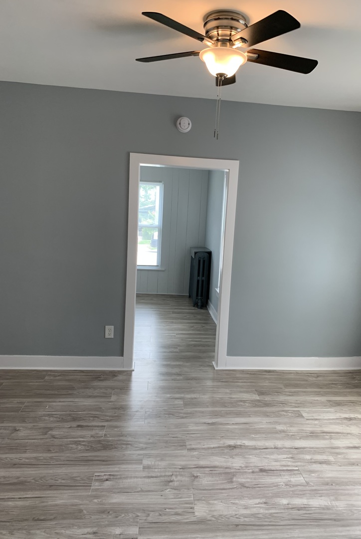 370 Ryerson Avenue Elgin, IL 60123 - Photo 9 of 21 a view of an empty room with wooden floor and a window
