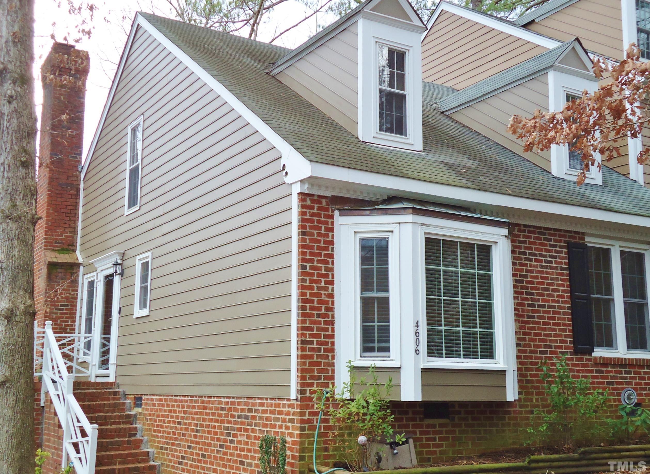 a view of a house with a window and brick walls