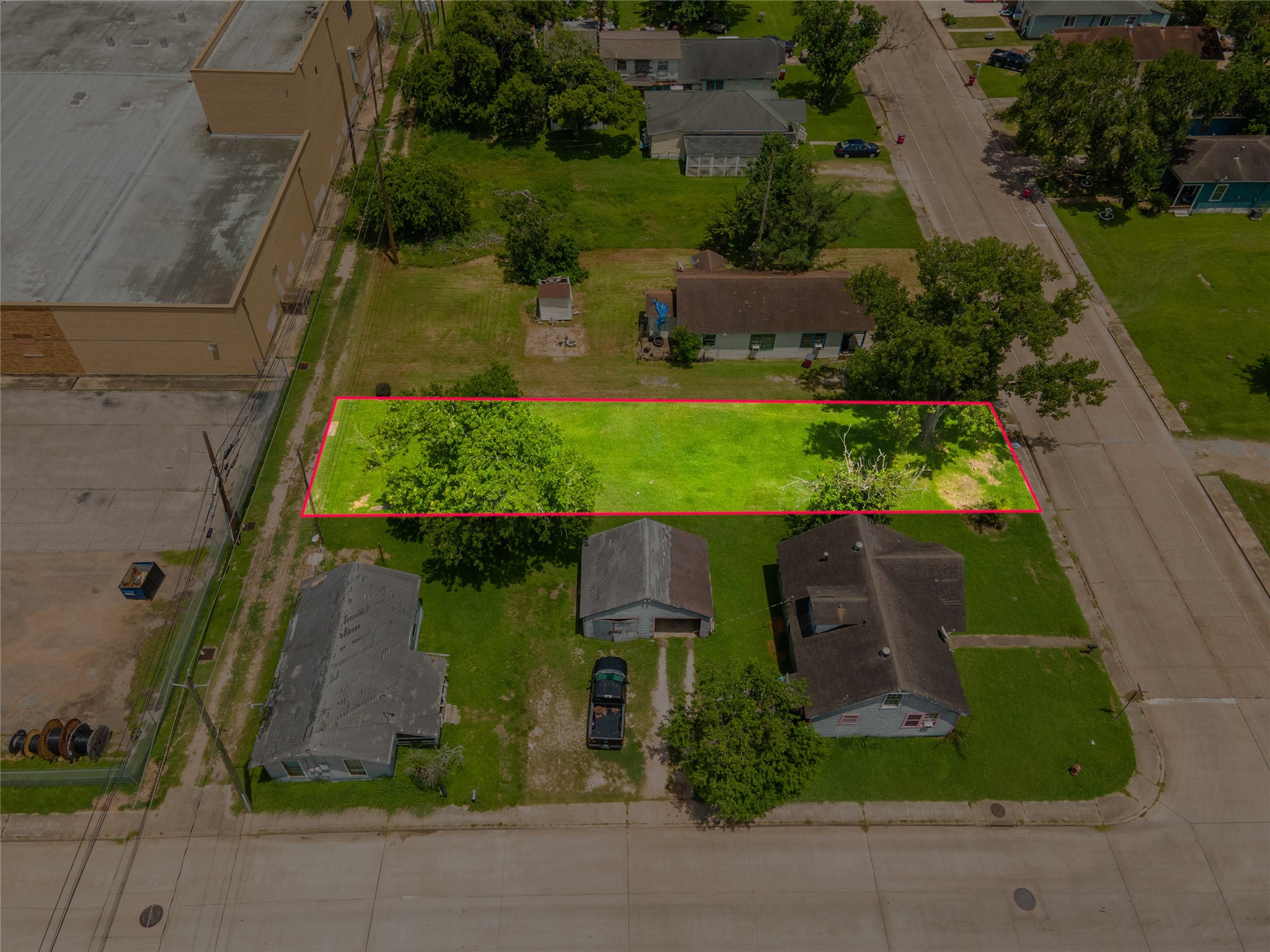 1026 West 4th Street Freeport, TX 77541 - Photo 8 of 12 an aerial view of a house with a yard basket ball court and outdoor seating