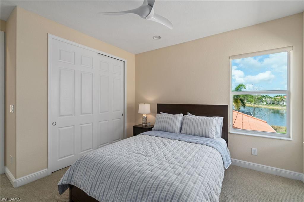 19753 Tesoro Way Estero, FL 33967 - Photo 24 of 47 a bedroom with a bed and wooden floor