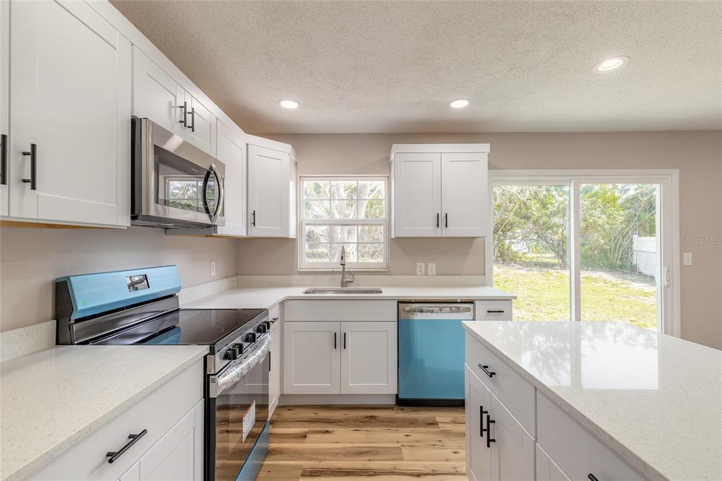 1605 Bradford Road Edgewater, FL 32132 - Photo 14 of 30 a kitchen with stainless steel appliances granite countertop a sink stove and cabinets