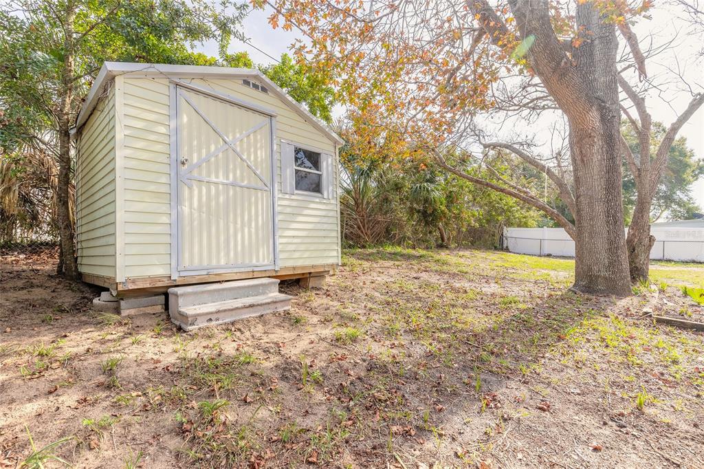 1605 Bradford Road Edgewater, FL 32132 - Photo 30 of 30 a view of a backyard with a large tree