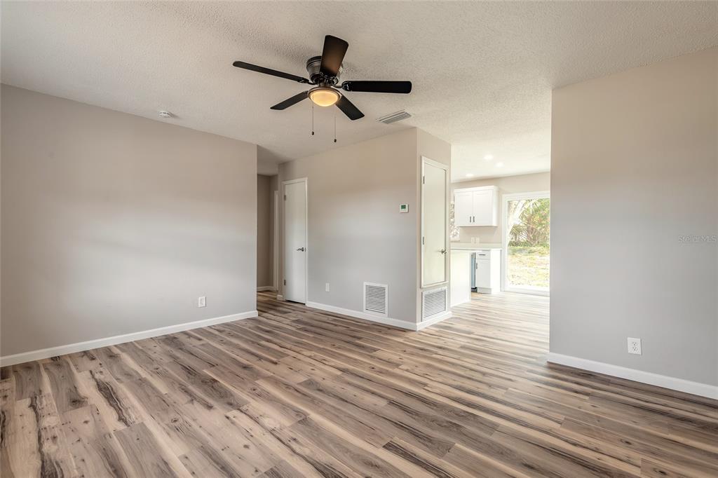 1605 Bradford Road Edgewater, FL 32132 - Photo 4 of 30 a view of a livingroom with wooden floor and a ceiling fan