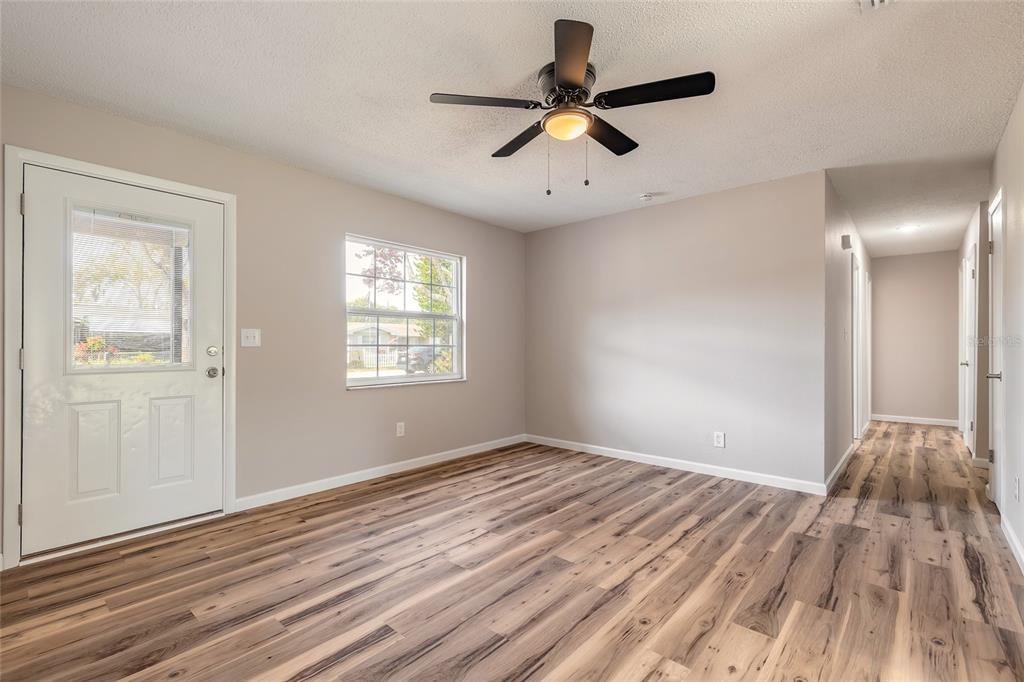 1605 Bradford Road Edgewater, FL 32132 - Photo 6 of 30 wooden floor in an empty room with a window