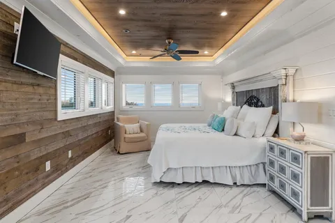 a living room with furniture and a view of kitchen