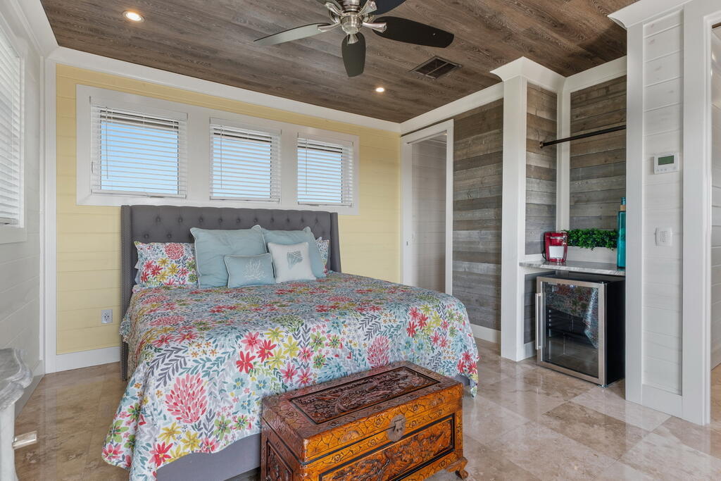 278 Savelle Drive Santa Rosa Beach, FL 32459 - Photo 99 of 157 a bed sitting in a bedroom next to a window and a chandelier
