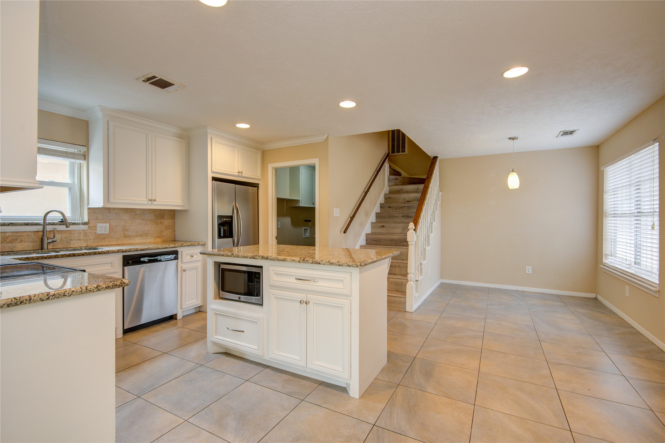 14211 Ella Lee Lane Houston, TX 77077 - Photo 11 of 42 a kitchen with a stove a sink and a refrigerator