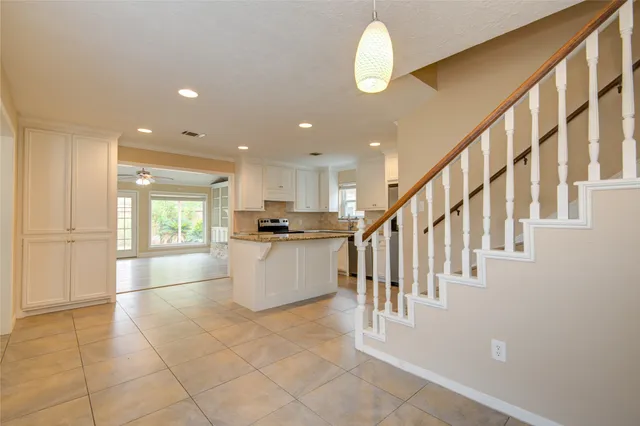 a view of kitchen with furniture and windows