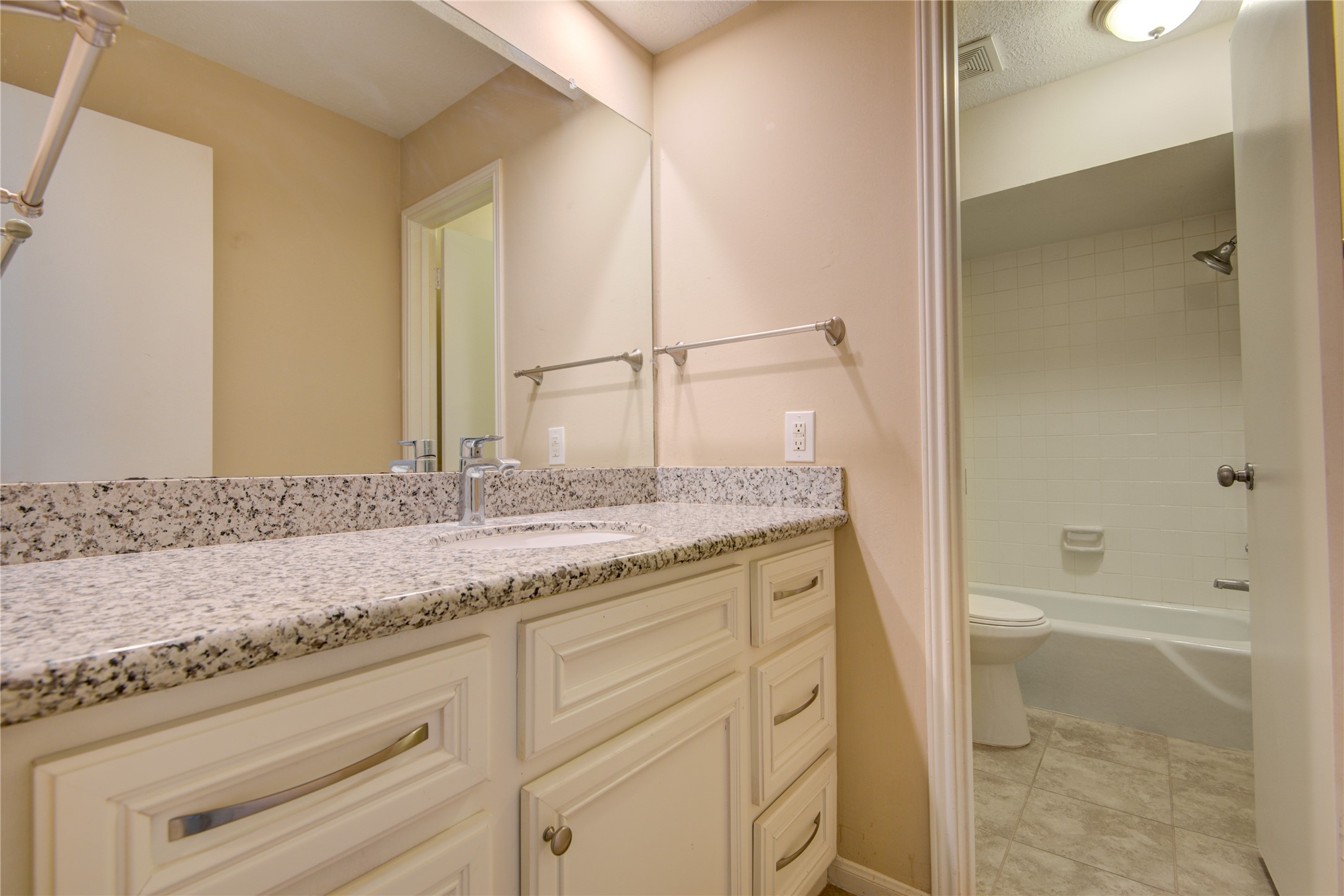 14211 Ella Lee Lane Houston, TX 77077 - Photo 20 of 42 a bathroom with a granite countertop sink and a mirror