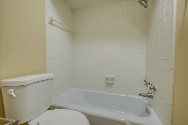 a bathroom with a bathtub and toilet