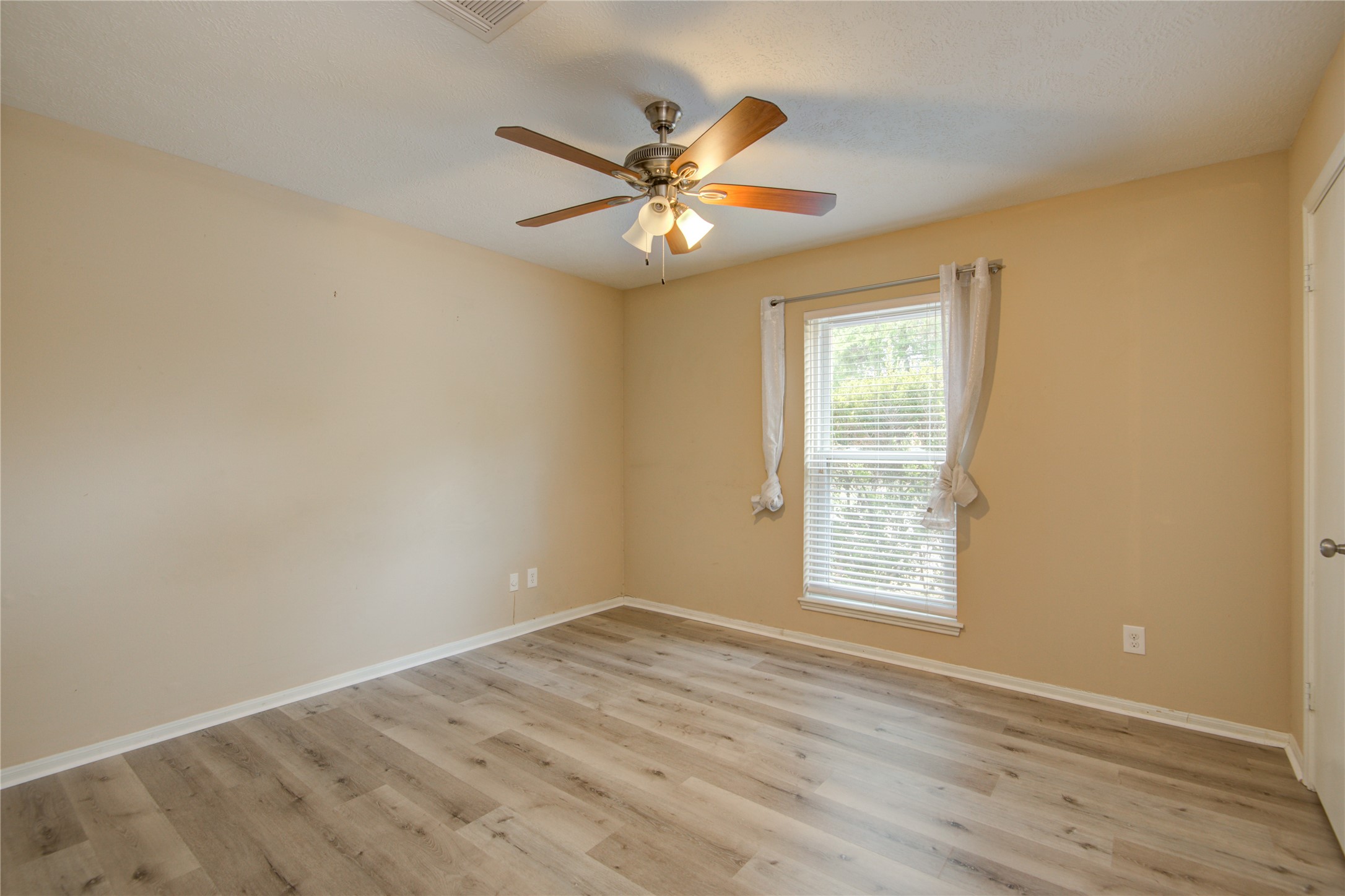 14211 Ella Lee Lane Houston, TX 77077 - Photo 24 of 42 wooden floor in an empty room with a window