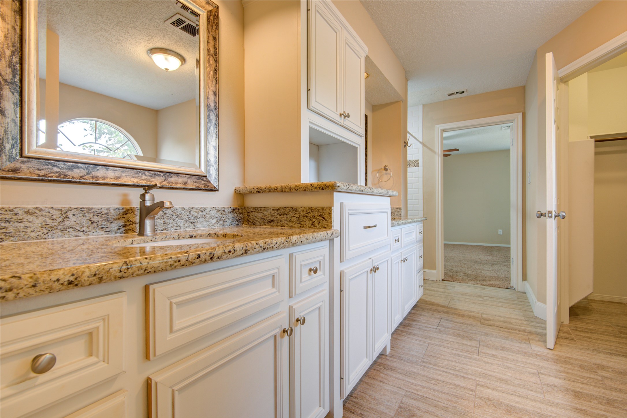 14211 Ella Lee Lane Houston, TX 77077 - Photo 33 of 42 a spacious bathroom with a granite countertop sink mirror and a