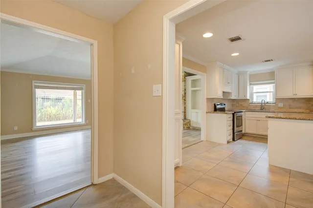 a kitchen with white cabinets and white appliances