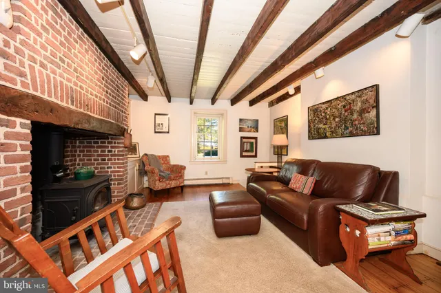 a living room with furniture a fireplace and a large window