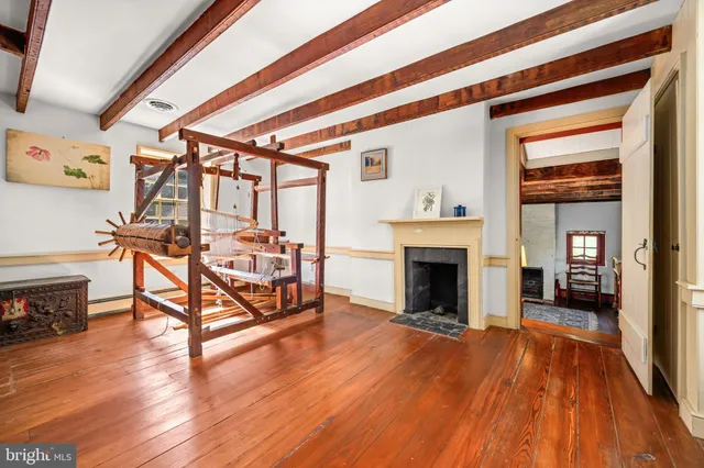 a bedroom with furniture fireplace and wooden floor